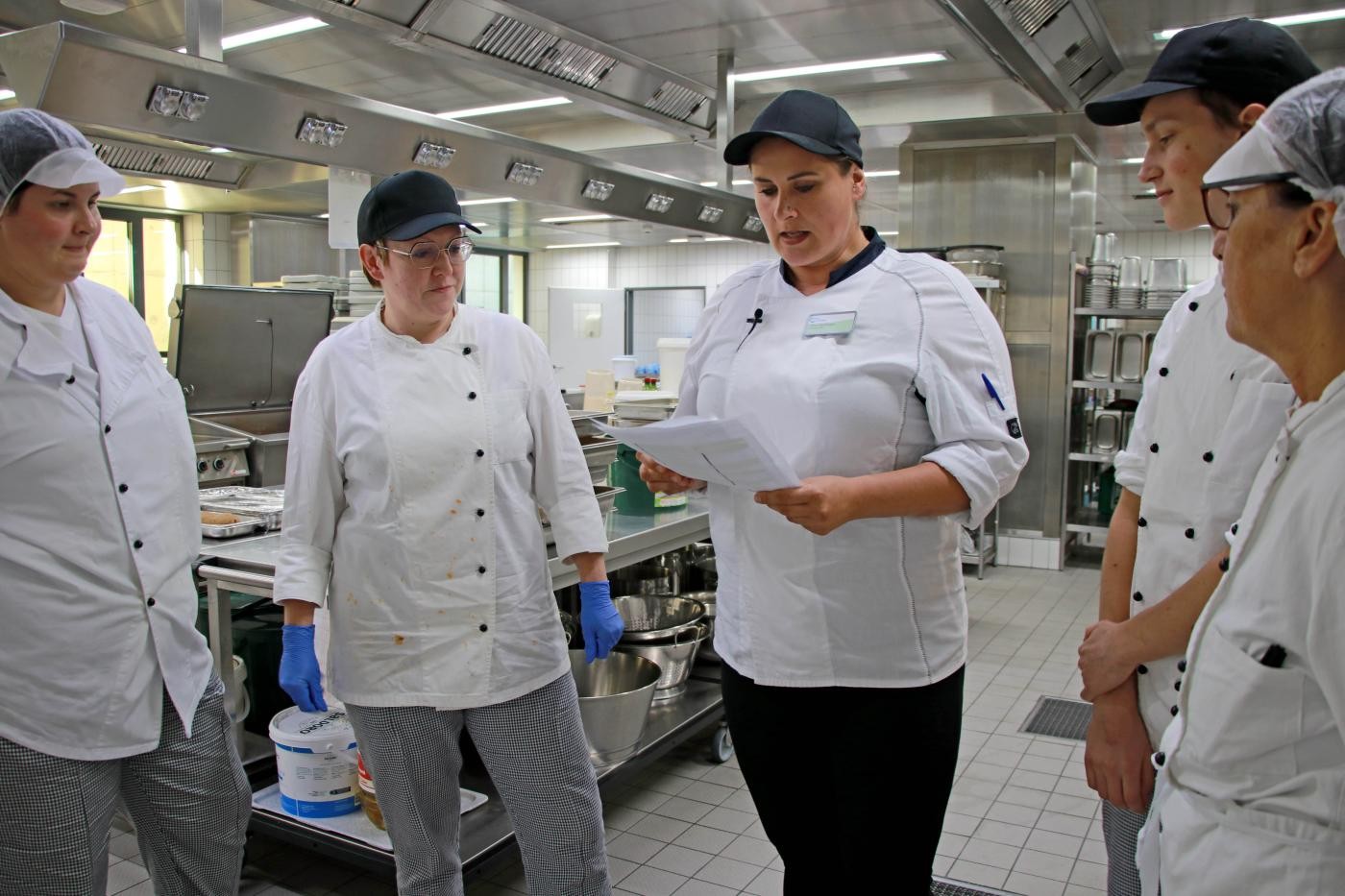 Mitarbeiter der Schulküche stehen zusammen